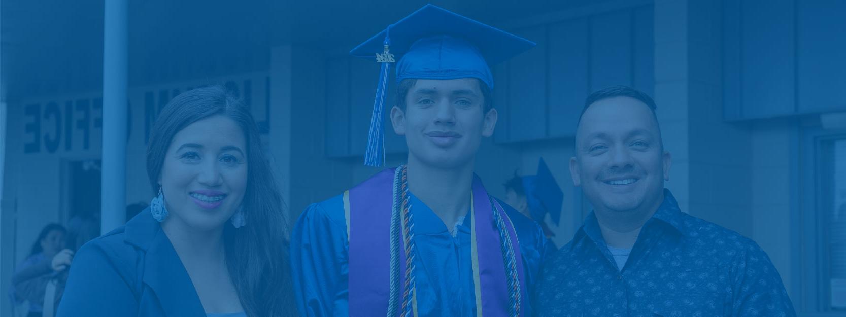 Student in Blue Cap and Gown Posing with Family After Graduation Ceremony